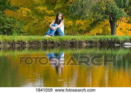 Reflection of a young woman in water View Large Photo Image Stock Photo - Reflection of a young woman in water. Fotosearch