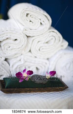 Picture - Rolled towels and spa rocks. Fotosearch