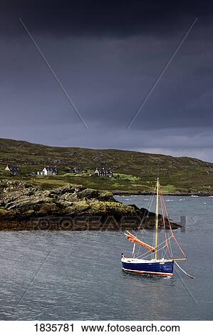 Stock Image - Sailboat on water, Colonsay, Scotland. Fotosearch