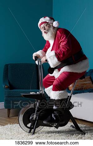 Stock Photo - Santa riding stationary bike. Fotosearch