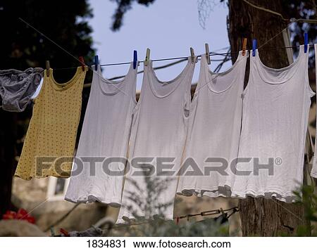 Shirts hanging out to dry View Large Photo Image Stock Image - Shirts hanging out to dry. Fotosearch