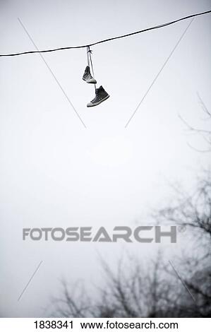 Shoes hanging from a line View Large Photo Image Stock Image - Shoes hanging from a line. Fotosearch
