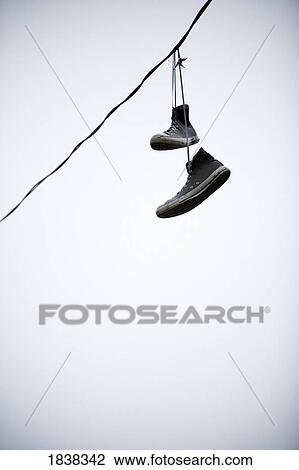 Shoes hanging from a line View Large Photo Image Stock Image - Shoes hanging from a line. Fotosearch