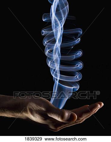Stock Photo - Smoke rising from a hand. Fotosearch