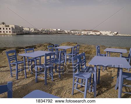 Stock Image - Table and chairs, Mykonos, Greece. Fotosearch