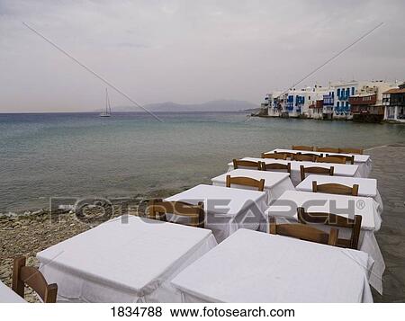 Stock Photo - Tables on the shore, Mykonos, Greece . Fotosearch