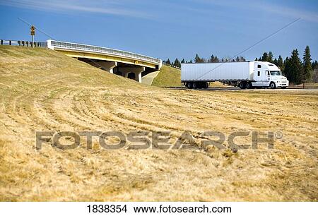Picture - Truck driving beside field. Fotosearch