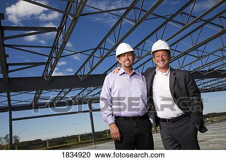 Stock Image - Two architects in front of a building. Fotosearch