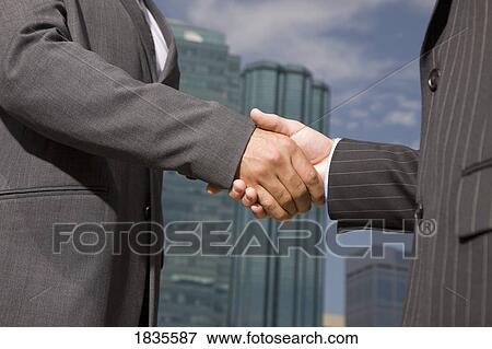 Two businessmen shaking hands View Large Photo Image Stock Photo - Two businessmen shaking hands. Fotosearch