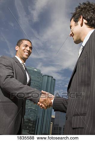 Two businessmen shaking hands View Large Photo Image Stock Photo - Two businessmen shaking hands. Fotosearch
