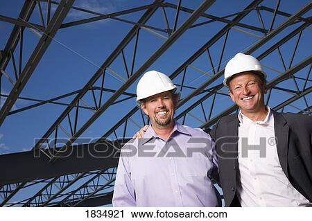 Two men in front of building View Large Photo Image Stock Image - Two men in front of building. Fotosearch