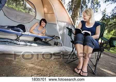 Two women at a campsite View Large Photo Image Stock Image - Two women at a campsite. Fotosearch