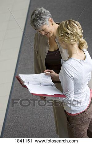 Stock Image - Two women having a conversation. Fotosearch