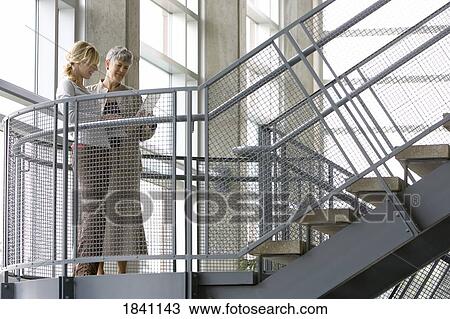 Two women having a discussion View Large Photo Image Stock Image - Two women having a discussion. Fotosearch
