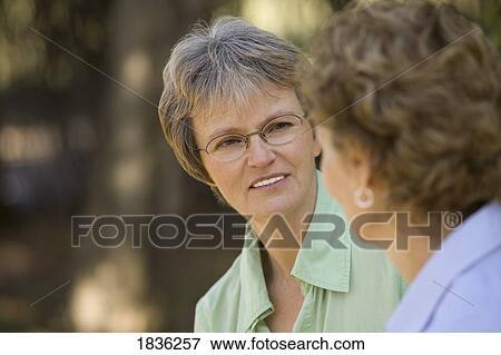 Two women looking at each other View Large Photo Image Stock Photo - Two women looking at each other. Fotosearch