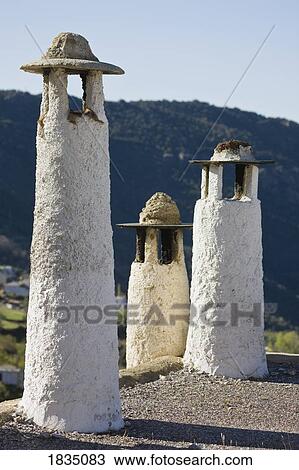 Stock Image - Typical chimneys on flat roofs, Capileira, La Alpujarra, Granada Province, Spain,. Fotosearch