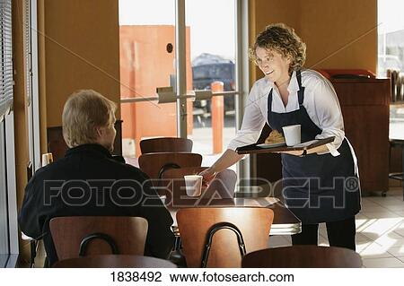 Waitress serving coffee View Large Photo Image Stock Image - Waitress serving coffee. Fotosearch