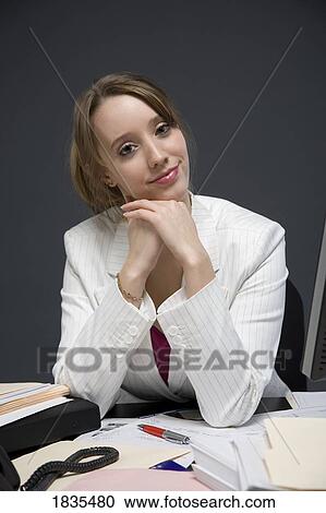 Woman at her desk View Large Photo Image Stock Image - Woman at her desk. Fotosearch