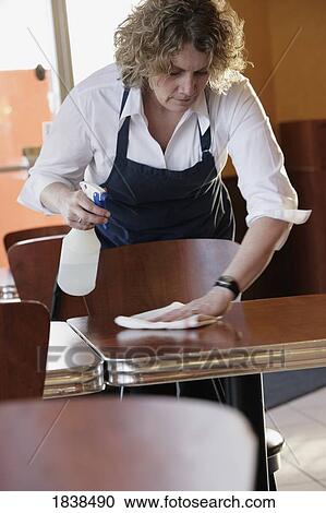 Woman cleaning tables View Large Photo Image Stock Image - Woman cleaning tables. Fotosearch