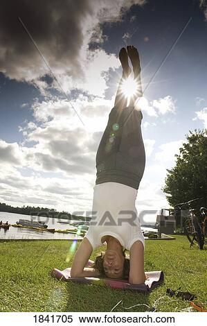 Stock Photography - Woman doing headstand. Fotosearch