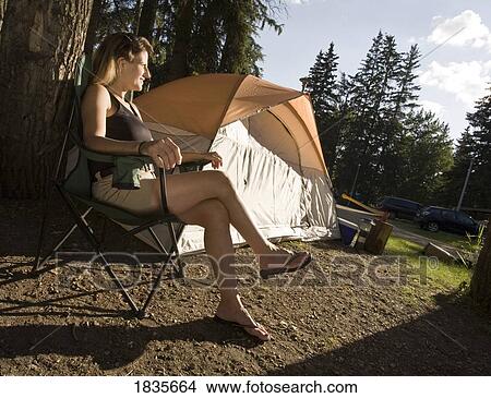Picture - Woman on campsite. Fotosearch