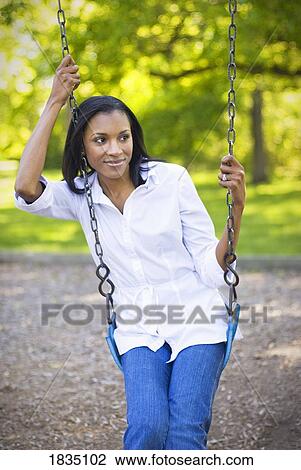 Woman sitting in swing View Large Photo Image Stock Image - Woman sitting in swing . Fotosearch