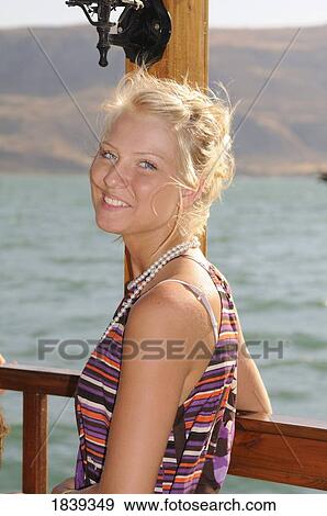 Stock Photo - Woman with Sea of Galilee in background, Israel. Fotosearch