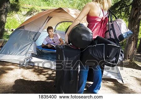 Young adults camping View Large Photo Image Stock Image - Young adults camping. Fotosearch