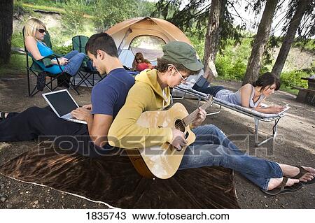 Young people at a campsite View Large Photo Image Stock Image - Young people at a campsite. Fotosearch