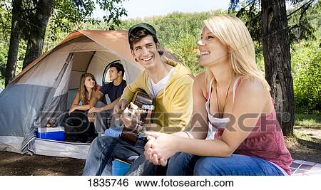 Stock Photograph - Young people at a campsite. Fotosearch