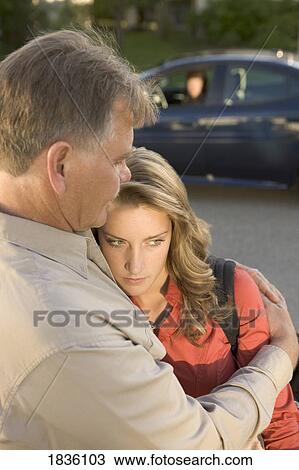 Stock Image - Young woman visiting dad. Fotosearch
