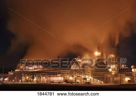 Stock Image - Alberta, Canada; Power plant and smog at night. Fotosearch