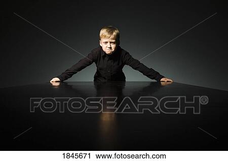 Angry boy; Boy standing at the end of a table View Large Photo Image Stock Image - Angry boy; Boy standing at the end of a table. Fotosearch