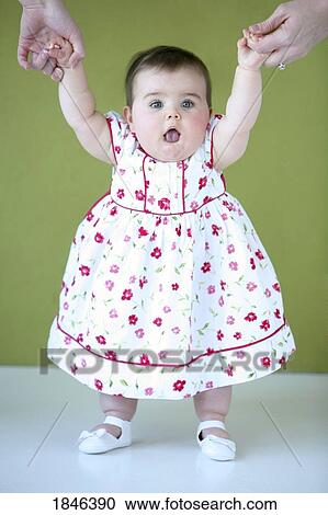 Stock Image - Baby girl standing. Fotosearch