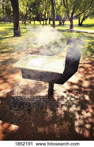 Barbecue in park; Cooking on a barbecue View Large Photo Image Stock Image - Barbecue in park; Cooking on a barbecue. Fotosearch
