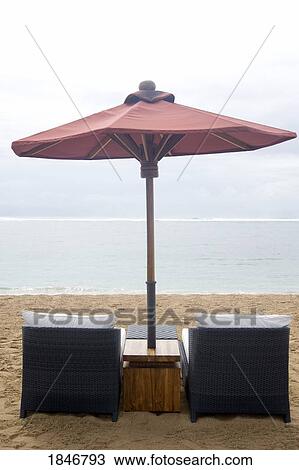Stock Image - Beach chairs and umbrella. Fotosearch
