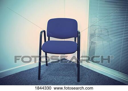 Blue chair in a corner beside a venetian blind View Large Photo Image Stock Image - Blue chair in a corner beside a venetian blind. Fotosearch