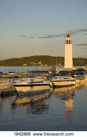Boats docked and lighthouse View Large Photo Image Stock Photo - Boats docked and lighthouse. Fotosearch