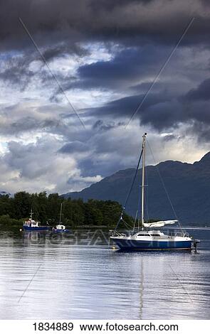 Stock Photo - Boats under stormy sky, Scotland. Fotosearch