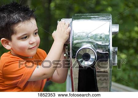 Stock Image - Boy and binoculars; Boy looking through binoculars. Fotosearch