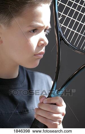 Stock Photo - Boy holding racquet. Fotosearch