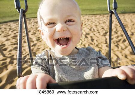 Stock Image - Boy in a swing. Fotosearch
