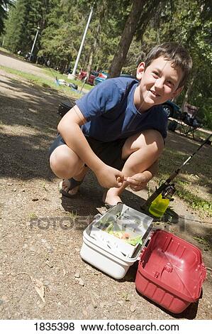 Boy preparing to go fishing View Large Photo Image Stock Photo - Boy preparing to go fishing. Fotosearch