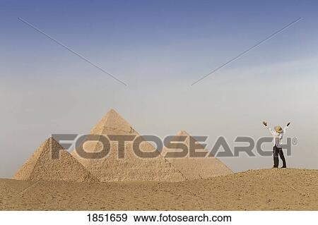 Cairo, Giza, Egypt; Tourist rejoicing at the Pyramids of Giza View Large Photo Image Stock Photo - Cairo, Giza, Egypt; Tourist rejoicing at the Pyramids of Giza. Fotosearch
