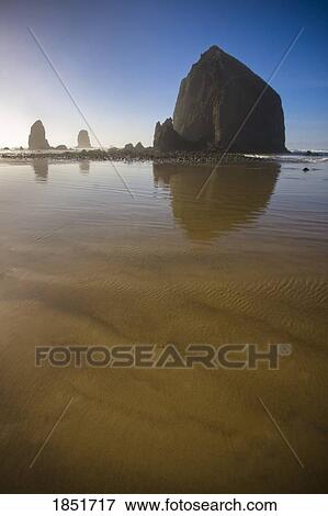 Cannon Beach, Oregon, USA; Haystack Rock a 235-foot (72-meter) tall monolith (or sea stack) View Large Photo Image Stock Photo - Cannon Beach, Oregon, USA; Haystack Rock a 235-foot (72-meter) tall monolith (or sea stack). Fotosearch