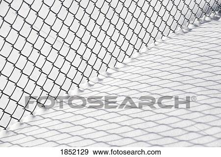 Chain link fence and shadow in snow View Large Photo Image Stock Photo - Chain link fence and shadow in snow . Fotosearch
