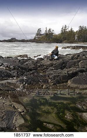 Chesterman beach, Tofino, Vancouver Island, British Columbia, Canada; man sitting on the beach View Large Photo Image Stock Photo - Chesterman beach, Tofino, Vancouver Island, British Columbia, Canada; man sitting on the beach. Fotosearch