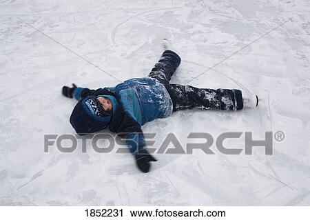 Stock Image - Child making snow angel. Fotosearch