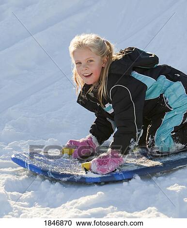Stock Image - Child playing in the snow. Fotosearch