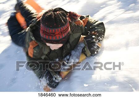 Stock Image - Child sledding. Fotosearch